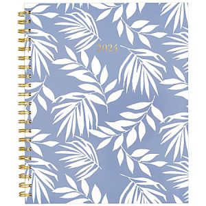 2024 planner with white leaf pattern on a blue background and a gold spiral binding.