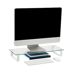 Modern computer on a glass stand with a keyboard, mouse, and notebooks neatly arranged underneath.