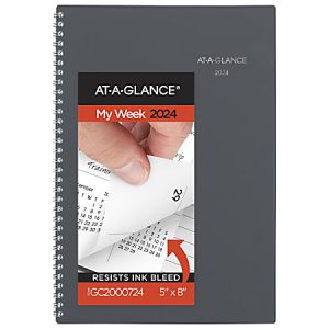 2024 spiral-bound planner with a hand flipping calendar pages. Cover labeled "AT-A-GLANCE My Week 2024" resists ink bleed.