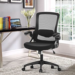 Black mesh ergonomic office chair on wheels in modern home office, next to a desk with a laptop and books, and a window view.