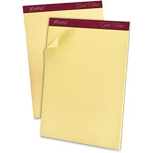 Two yellow legal pads with maroon headers and graph paper sheets, one slightly flipped open.