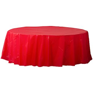 Round table with a bright red plastic tablecloth draped over it.