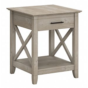 Gray wooden side table with a drawer, black handle, X-shaped side panels, and a lower shelf. Rustic design.