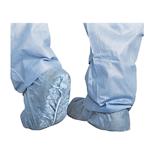 Person wearing blue disposable shoe covers and matching pants, showing the back view of the feet with one foot turned.