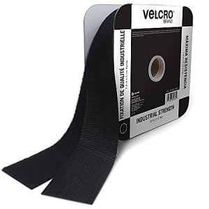 Roll of industrial-strength Velcro tape with black hook and loop sides, displayed on branded packaging.