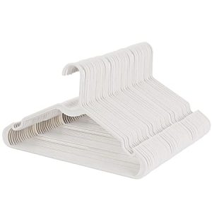 Stack of white plastic hangers with grooved shoulders for non-slip grip, angled and arranged in a neat pile.