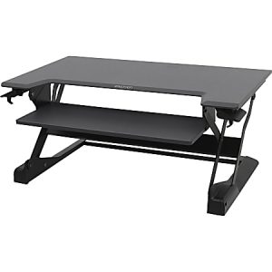Black adjustable standing desk converter with two tiers, designed to elevate a workspace for ergonomic comfort.