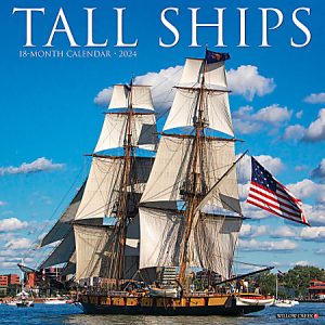 Sailing ship on calm water with an American flag, against a blue sky, featured on the Tall Ships 2024 calendar cover.