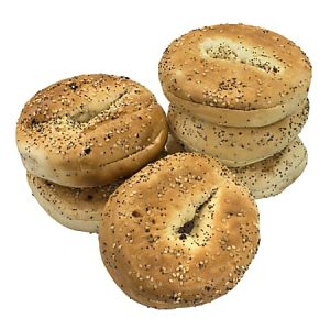 Six sesame seed bagels stacked in two piles on a white background.