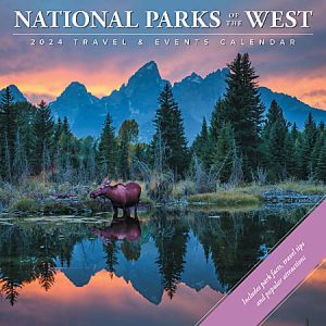 Moose in a tranquil lake with forest and mountain backdrop at sunset, featured on 2024 National Parks of the West calendar.