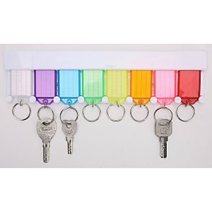Colorful key tags on a rack with six keys attached, organized by shades from white to red, hanging below each tag.