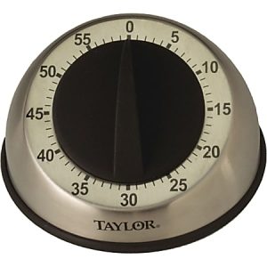 Silver manual kitchen timer set to zero, with black numbers and knob, branded Taylor.