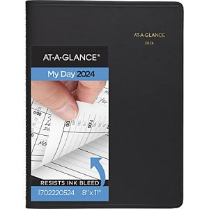 Black AT-A-GLANCE 2024 planner with a hand turning a page, highlighting "Resists Ink Bleed" feature, size 8" x 11".