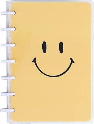 Yellow notebook with a large black smiley face on the cover and white rings binding the left side.