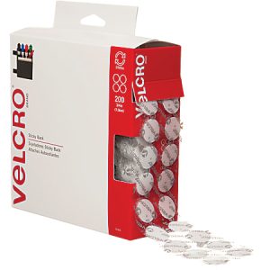 Box of Velcro adhesive dots, open and dispensing circular sticky back fasteners, labeled for easy access and storage.