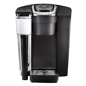 Black Keurig coffee maker with a water reservoir and digital display, featuring a sleek design for single-serve brewing.